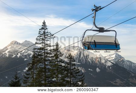 Sky Lift On A Cableway, Over Fir Trees And Through The Snow-capped Alps Mountains, In Ehrwald, Austr