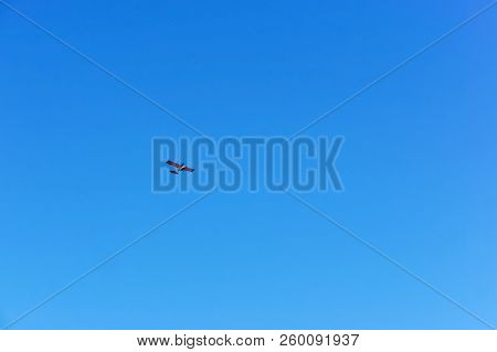 Glider In The Sky, A Small Aircraft Soars In The Blue Sky