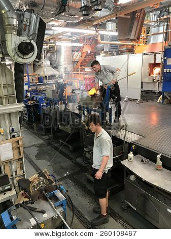 Man Maticulously Works On Glassblowing And Shaping  In The Factory Of House Of Waterford Crystal Fac