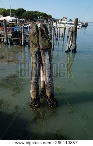 VENICE, ITALY - MAY 28 : Wooden mooring poles in the sea on the way from Lido di Jesolo to Venice, Italy, on May 28, 2017.