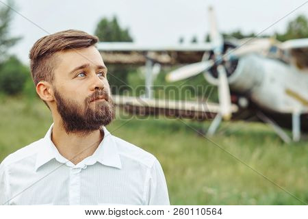The Man In The Shirt Stands At The Old Plane