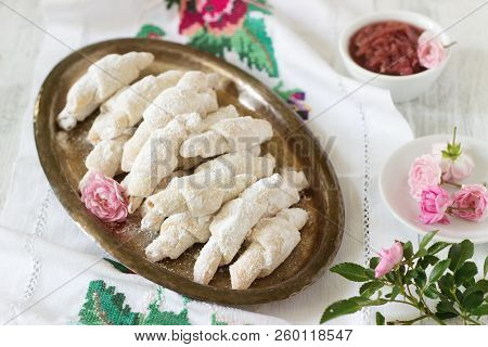 Traditional Romanian Or Moldavian Shortcake Cookies With Jam Stuffing And A Cup Of Tea On The Light 