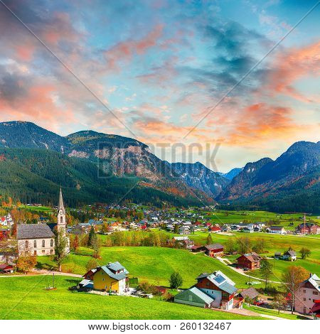 Alpine Green Fields And Traditional Wooden Houses View Of The Gosau Village At Autumn Sunny Day. Loc