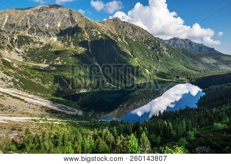 Landscape of High Tatras in the spring. Snowy mountain tops and beautiful sky. Mountain Rysy, Morskie Oko