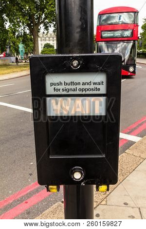 London, Uk - June 9, 2015: Black Crosswalk Button Box Mounted On A Pole Near A Pedestrian Crossing. 