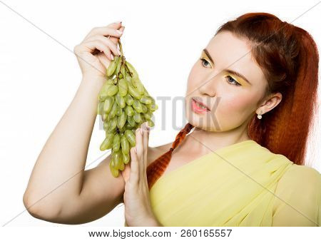 Beautiful Redhead Woman Licks Grapes. Concept Of Healthy Eating