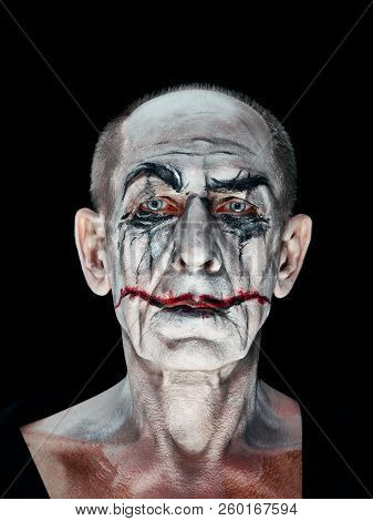 Bloody Halloween Theme: The Crazy Maniak Face On Dark Studio Background