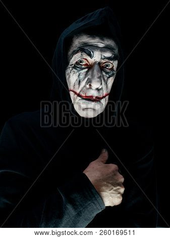 Bloody Halloween Theme: The Crazy Maniak Face On Dark Studio Background