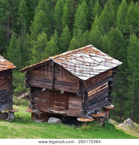 Traditional Rural Architecture In Zermatt, Old Timber Sheds With Stone Roofs.
