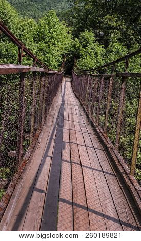 Suspension Bridge Over A Mountain River In The Carpathians