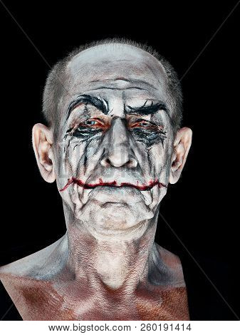Bloody Halloween Theme: The Crazy Maniak Face On Dark Studio Background