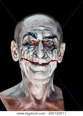 Bloody Halloween Theme: The Crazy Maniak Face On Dark Studio Background