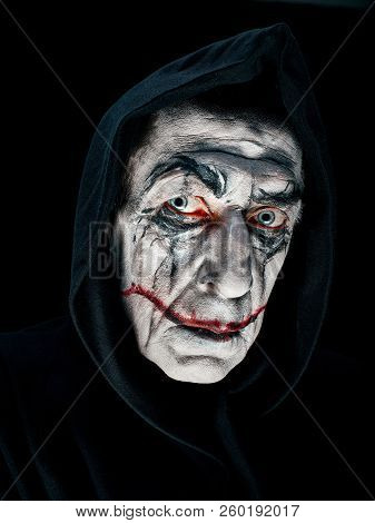 Bloody Halloween Theme: The Crazy Maniak Face On Dark Studio Background