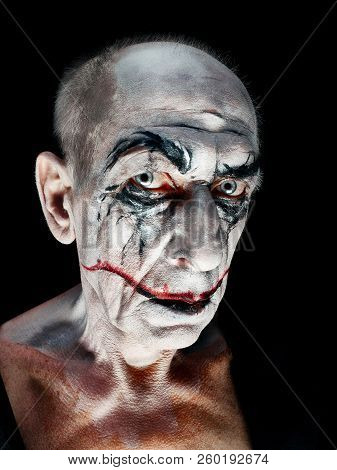 Bloody Halloween Theme: The Crazy Maniak Face On Dark Studio Background