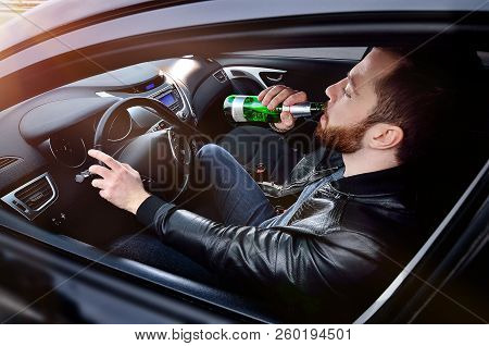 Drinks alcohol in the car. The guy with beer at the wheel. Man with beer. emergency situation. Socia