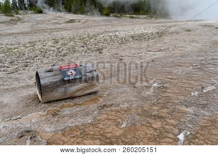 A Log With A Warning Sign Warns Tourists And Visitors To Stay Out Of The Thermal Areas In Yellowston