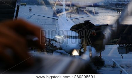 Woman Hands Typing On The Keyboard On The Laptop By The Window At The Airport On The Background Of T