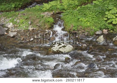 Mountain River In Resort Sairme. Beautiful River Clear Water Flowing Through Stones. Clean Mountain 