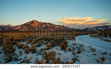 Wide Angle Golden Hour Sunset Special Clouds Luming Over The Peaks Rising Southwestern Taos Mountain