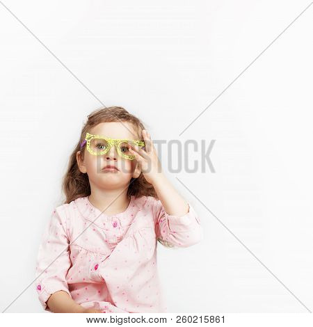 Portrait Of Funny Little Girl Whearing Yellow Toy Plastic Hand Made Glasses