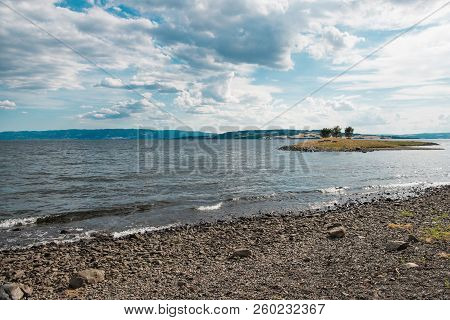 Scenic View Of Mjosa Lake With Small Island And Cloudy Sky, Hamar, Hedmark, Norway