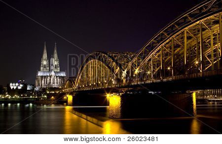 Koln - 2 de abril: Tiro de noite dom de Colônia e ponte Hohenzollern 2 de abril de 2009, em Colónia, Alemanha