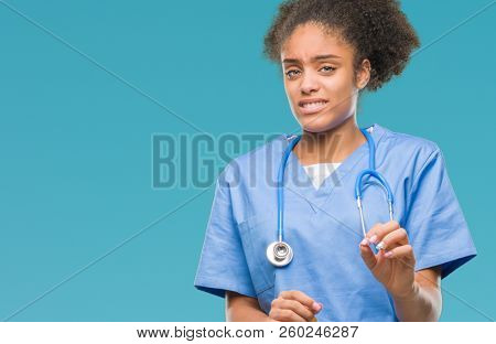 Young afro american doctor woman over isolated background disgusted expression, displeased and fearful doing disgust face because aversion reaction. With hands raised. Annoying concept.
