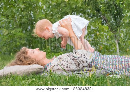 Little Princess Playing Outdoor. Baby Girl On Mother's Hands. Smiling Toddler With Mother. Life Begi
