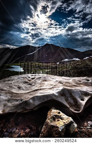 Sun Shines On A Chunk Of Snow Colorado Mountains