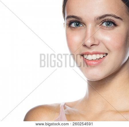 portrait of attractive young caucasian smiling woman  isolated on white studio shot  face  head and shoulders looking at camera happy smiling cheelful