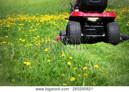 Tractor Lawn Mower Cutting The Grass In Springtime