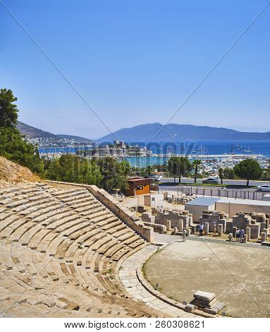 Bodrum, Turkey - July 6, 2018. Tourists Visiting The Amphitheatre Of Halicarnassus With Kumbahce Bay