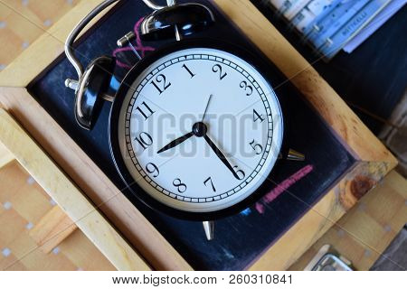 9.30 Am/pm Back To School Concept. Alarm Clock On Wooden With Blackboard On Background