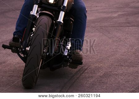 Biker Iriding A Motorcycle. Front View. Soft Focus