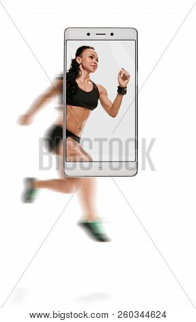 Dynamic Photo Of Young Athletic Woman Running Race. Conceptual Image With A Smartphone, Demonstratio