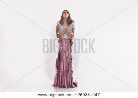 Girl In Pink Dress With Angel Wings On White Background. Angel-woman
