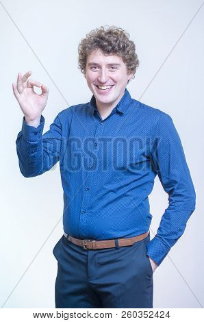 Portrait Of Young Caucasian Ethnicity Funny Curly Man Showing O.k. Sign With Fingers On White Backgr