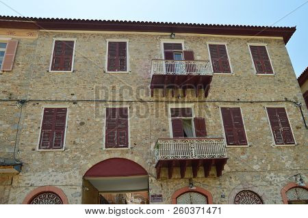 Beautiful Brick Buildings Light Brown With Nice Red Windows In Nauplion. Architecture, Travel, Landscapes, Cruises. July 8, 2018. Nauplion Argolida Greece.