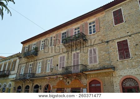 Beautiful Brick Buildings Light Brown With Nice Red Windows In Nauplion. Architecture, Travel, Landscapes, Cruises. July 8, 2018. Nauplion Argolida Greece.