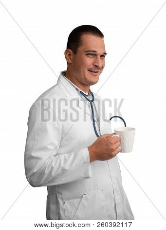 Young Male Doctor With A Mug In His Hand Is Having Fun Watching