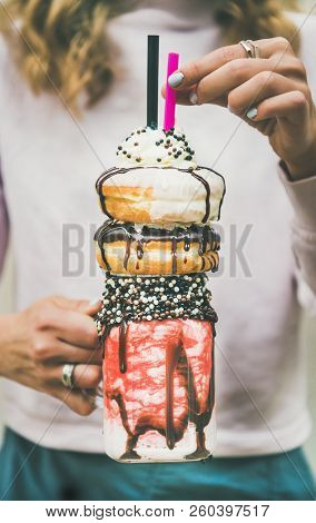 Girl Holding Cold Strawberry Donut Freakshake In Hands