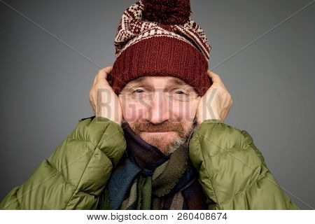 Handsome Mature Man Freezing In Warm Clothing