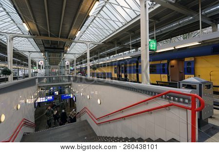 AMSTERDAM, NETHERLANDS - JANUARY 1, 2017: People on the platform of metro and train station. The metro system consists of five routes and serves 58 stations, with a total length of 52.2 km