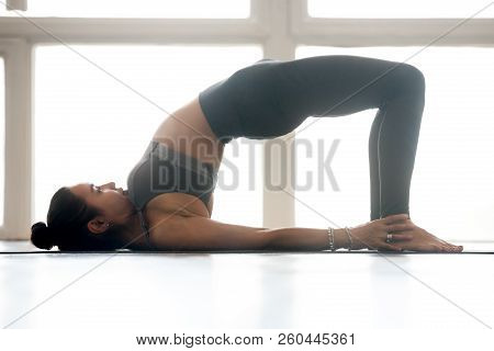 Young Sporty Woman Practicing Yoga, Doing Dvi Pada Pithasana Exe