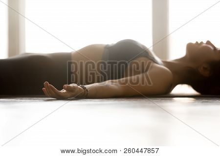 Young Woman Practicing Yoga, Corpse Pose, Close Up