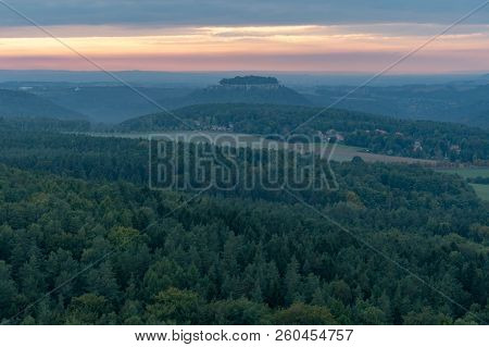 View To A Sunset Over Forest And Rock