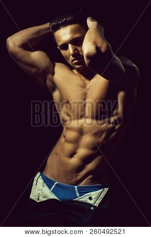 Young Handsome Man With Bare Torso And Sexy Muscular Body In Trausers In Studio