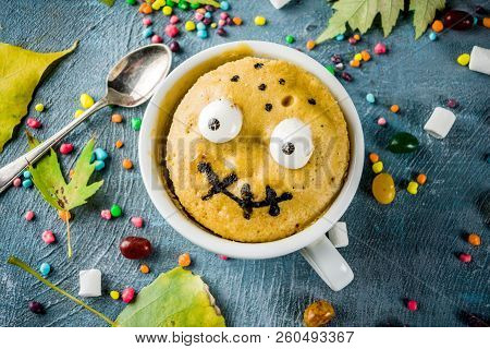 Kids Halloween Food Idea, Funny Mug Cake Decorate Like Monster Face With Marshmallow Eyes And Mouth 