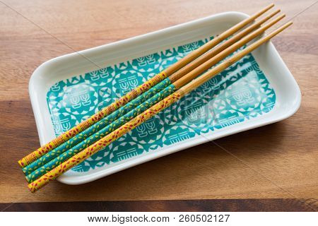Natural Bamboo Chopsticks And Plate On Wooden Table Background.