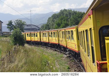 Latour De Carol - September 4, 2018: The Small Yellow Train Of The Pyrenees Crossing A Beautiful Mou